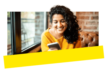 Jeune professionnelle qui utilise GoTo Meeting sur son appareil mobile dans un café.