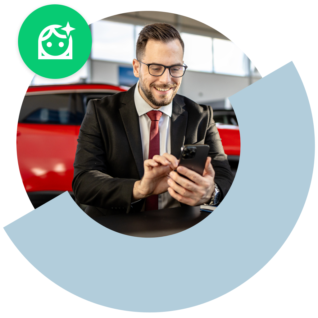 Man in a dealership using a cell phone.